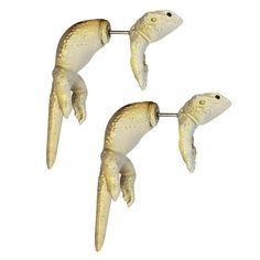 three white seagulls hanging from hooks on a white background in the shape of fish