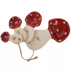 a red and white ceramic telephone with polka dots on it's back end, attached to a cord