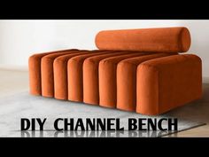 an orange couch sitting on top of a floor next to a white wall with the words diy channel bench