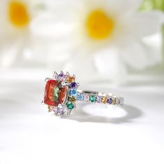 With its classic design and sparkling stones, this ring is a beautiful complement to any attire. Well-crafted in sterling silver, the eye is drawn to the brilliant cushion cut center stone. A halo frame of colorful round stones wraps center stone in a sparkling embrace, while additional colorful stones line the ring's polished shank. Simple and stunning, it's certain to become a treasured favorite.Carat Weight: 2.8 ctStone Size: 7*7 mmStone Type: Jeulia® StoneNumber of Stones: 1 Stone Color: WatermelonStone Shape: PrincessCarat Weight: 0.776 ctStone Size: 1.5,1.7 mmStone Type: Jeulia® StoneNumber of Stones: 32 Stone Color: Aquamarine Blue, Emerald GreenStone Shape: RoundWeight: 3.52 gWidth: 11.3 mmHeight: 6.5 mmThickness: 2.7 mmMaterial: 925 SilverPlating Color: Silver Color Engagement Rings, Jeulia Jewelry, Classic Cushions, Silver Rings For Women, Colorful Stones, Blue Emerald, Colored Engagement Rings, Stone Wrapping, Cushion Cut