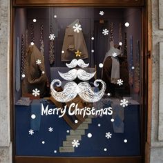 a christmas window display with a mustache and moustache on it's side