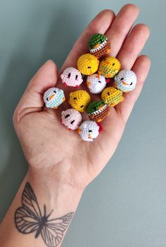 small crocheted animals are held in the palm of a person's hand