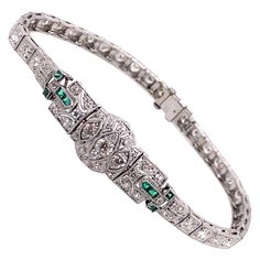 Vintage 1930's Art Deco Platinum Diamond and Emerald Bracelet - The bracelet contains 33 European cut diamonds that weigh approximately 2.50ct, and an additional 32 single cut diamonds that weigh approximately .50ct. The diamond quality is G - I color and VS - SI clarity. There are 8 French cut emeralds that weigh approximately .25ct. The bracelet measures 7.25 inches long, .40 inches wide in the middle and .16 inches wide along the rest of the bracelet. The clasp is a plunger style with a safet Bracelet Art, Retro Bracelet, Emerald Bracelet, French Cut, 1930s Art Deco, Deco Jewelry, European Cut Diamonds, Diamond Bracelets, Vintage Stil