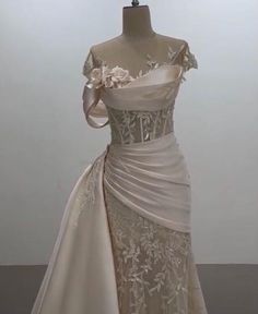 a wedding dress on display in a room