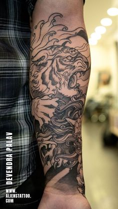 a man with a dragon tattoo on his arm