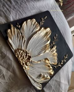 a black and gold tray with flowers on it