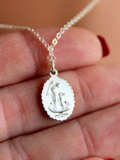 "Dainty sterling silver Saint Joseph charm necklace for women. This beautiful detailed oval charm is 925 sterling silver, measures 16x11 mm and comes on shiny 925 sterling silver cable chain with spring clasp. Image features Saint Joseph holding a baby Jesus. Reverse side shows and angel protecting a child. Model is wearing 16\" length in photos. Comes in many lengths. Comes in a gift box ready to present. CHOSE YOUR LENGTH." Silver Oval Pendant Necklace With Sterling Clasp, Silver Oval Pendant Necklace With Sterling Silver, Silver Sterling Silver Charm Necklace With Oval Pendant, Silver Sterling Oval Charm Necklaces, Silver Sterling Silver Oval Pendant Charm Necklaces, Silver Oval Pendant Charm Necklace In Sterling Silver, Silver Oval Sterling Silver Charm Necklace, Oval Silver Sterling Silver Charm Necklaces, Sterling Silver Oval Necklace With Silver Clasp