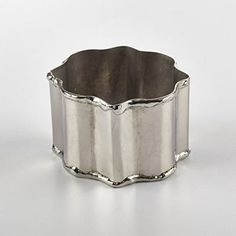 a silver ring sitting on top of a white table