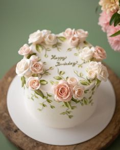 a white cake with pink flowers on it