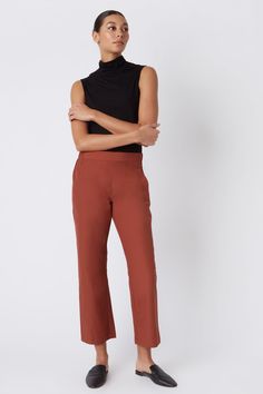 Fall calls for ease with our elastic waist Brit Crop Pant. With a mid-rise fit, angle seam pockets and the perfect leg opening, this style is a breeze to wear in the cooler weather. Pair it with your favorite ankle boot or sneaker, this style is designed for women on the go.THIS ITEM IS FINAL SALE. 1.5" front waistband, elastic at sides and back, angle seams with front pockets, midrise, easy fit, clean finish hem. - 51% Cotton, 49% Nylon - Fabric Woven in Italy - Made in NYC - Professional dry c Pull-on 4-way Stretch Dress Pants For Work, Fitted Straight Pants With Pull-on Style, Casual Straight Leg Pull-on Dress Pants, Business Casual Straight Dress Pants With Pull-on Style, Chic Workwear Pants With Comfort Waistband, Chic Pants With Comfort Waistband For Work, Fitted Full Length Bottoms With Elastic Side Panels, Ankle-length Dress Pants With Elastic Waistband And 4-way Stretch, Chic Relaxed Fit Pants With Comfort Waistband