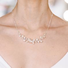 Minimalist bridal dainty necklace for a wedding. Pearl bridal necklace for a wedding in ivory color. Every bride dreams of the perfect wedding and carefully thinks over the image for the solemn moment. These pleasant chores take a lot of time and effort because, for such an event, you need to choose an outfit and bridal necklace that will complement the gentle image. The dainty pearl bridal necklace will be harmoniously combined, complementing but not overshadowing the bride's outfit. Their style will match the dress, the hairstyle, and, in fact, the event itself. Details: * Designed with rhinestones and pearls; * Length of the necklace - 17 inches (43 cm); * Size of the necklace is adjustable; * Finish: ivory silver; * Lightweight for easy day-to-night wearing. Customization: If you need Elegant Pearl Chain Bridal Necklace, Elegant Pearl White Necklaces For Weddings, Delicate Bridal Pearl Necklace With Adjustable Chain, Elegant Pearl White Wedding Necklace, Elegant White Wedding Necklaces, Delicate Anniversary Necklace With Elegant Design, Minimalist Pearl Chain Bridal Necklace, Delicate Pearl Chain Jewelry For Wedding, Dainty Necklace With Delicate Chain For Wedding