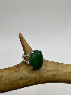 vintage green fun jade ring  Setting is a silver finished bronze setting  This is one of my hand re finished treasures. Salvaged from vintage.  Size  7 Re sizing can be done for a $20 fee and may take up to a week.  Engraving is $4 per letter.  Thank you for supporting a veteran's small business. All jewelry is shipped free within the US in a stylish gift box Luxury Green Oval Gemstones, Fine Jewelry Emerald Green Oval Cabochon Ring, Elegant Green Cabochon Emerald Ring, Green Oval Cabochon Emerald Ring, Elegant Green Emerald Cabochon Ring, Oval Green Diamond Gemstones, Green Diamond Gemstones For May Birthstone, Oval Diamond Gemstones With Accents, Formal Crystal Diamond Ring With Stones