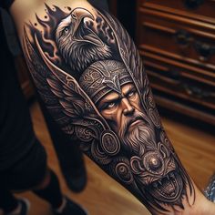 a man's arm with an eagle and head tattoo design on the left forearm