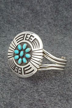 This stunning bright-polish sterling silver bracelet was made by Navajo silversmith Rosco Scott. The inside of the cuff is signed Rosco Scott and stamped sterling.Size: 5 3/4" (will fit up to a 6 3/4" wrist)Gap: 1"Width: 1 7/8"Cuff Width: 1/2"Free shipping on all orders! We ship with USPS and always include tracking. All orders ship within a day of payment.Returns are accepted up to 30 days after you receive your order. Just send us a message. Our shop offers cash back or store credit. The item must be returned in new condition. Southwestern Style Jewelry Bracelet With Inlay, Southwestern Style Bracelet With Inlay, Southwestern Inlay Bracelet, Southwestern Stamped 925 Cuff Bangle Bracelet, Traditional Turquoise Sterling Silver Cuff Bracelet, Southwestern Sterling Silver Cuff Bracelet In Blue, Southwestern Turquoise Sterling Silver Cuff Bracelet, Southwestern Style Polished Bangle, Southwestern Silver Cuff Bracelet With Inlay