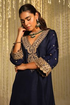 Deep blue long kaftan with placed thread embroidered paisley motifs embellished by sequins. Comes with matching doghri salwar.
Components: 2
Pattern: Embroidered
Type Of Work: Thread, Sequin
Neckline: V-neck
Sleeve Type: Three quarter
Fabric: Silk Dupion
Color: Blue
Other Details: 
Flared silhouette
Occasion: Sangeet,Mehendi and Haldi - Aza Fashions Traditional V-neck Semi-stitched Salwar Kameez, Eid V-neck Kurta With Intricate Embroidery, Semi-stitched V-neck Dress For Festive Occasions, Semi-stitched V-neck Festive Dress, Elegant V-neck Kurta For Festive Occasions, Elegant V-neck Kaftan For Festive Occasions, Traditional V-neck Wedding Sets, Festive V-neck Salwar Kameez With Zari Work, Festive V-neck Salwar Kameez For Wedding