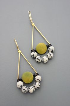 Gold plated brass hooks with black vulcanite, green painted wood, and Dalmatian beads. Each earring weighs .195 oz. and measures 3 inches long. Unique Green Jewelry With Black Beads, Unique Wooden Bead Dangle Jewelry, Unique Wooden Beads Dangle Jewelry, Adjustable Dangle Jewelry With Wooden Beads, Brass Hooks, Jewelry Making Earrings, Brass Hook, Making Earrings, Multi Strand Necklace