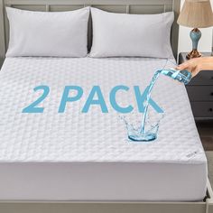 someone is pouring water into a bed with the words 2 pack written on it in blue