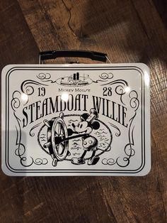 a metal box with an image of a steampot willie machine on it's side