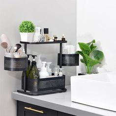 a white sink sitting under a bathroom mirror next to a shelf filled with bottles and soaps