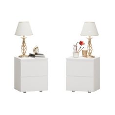 two white nightstands with lamps on top of them