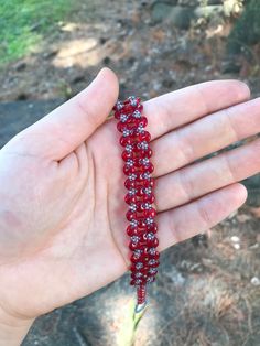 Opaque Red handmade lentil bracelet. I stitched this bracelet using a needle and fireline beading thread. It is made with red two hole lentil beads and size 15 seed beads. This bracelet is 7 and 3/4 inches long and 1/2 an inch wide. Metal free, and perfect for people with allergies to copper, iron, gold, or silver! :)   Materials *czech beads *fireline  *seed beads (size 15) *two hole lentil beads  Feel free to message me with any questions about this product Handmade Red Bohemian Crystal Bracelet, Handmade Bohemian Red Crystal Bracelet, Red Beaded Bracelets For Festival With Tiny Beads, Red Tiny Beads Bracelets For Festival, Adjustable Red Friendship Bracelets With Spacer Beads, Red Beaded Friendship Bracelets, Red Crystal Bracelet With Spacer Beads, Red Bohemian Crystal Bracelet With Round Beads, Adjustable Red Friendship Bracelets