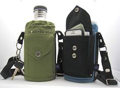 two cell phones are sitting next to each other in their pouches and one is holding a water bottle