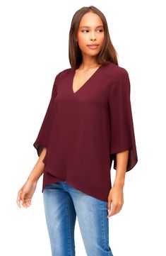 An elegant top of silky, lightweight crepe delivers elegant movement with its angled flare sleeves and fluttery asymmetrical hemline that dips low in back. 25 1/2" length (size Medium) V-neck Three-quarter sleeves Back yoke with gathering Crossover high/low hem 100% polyester Dry clean or hand wash, line dry Made in the USA of imported fabric Women's Clothing Chic Viscose Top With Asymmetrical Hem, Chic Viscose Tops With Asymmetrical Hem, Chic Flowy Blouse With Asymmetrical Hem, Elegant Asymmetrical Hem Tops For Work, Elegant Asymmetrical Blouse With Draped Sleeves, Elegant Asymmetrical Blouse For Fall, Elegant Tops With Asymmetrical Hem For Fall, Elegant Fall Top With Asymmetrical Hem, Elegant Blouse With Draped Asymmetrical Sleeves