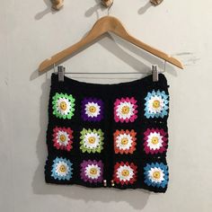 Elevate your bohemian style with our Crochet Daisy Granny Square Skirt - a captivating fusion of nostalgia and contemporary fashion. This floral-inspired crochet skirt is a celebration of femininity and creativity, perfect for women who love to stand out in the crowd. Each meticulously crafted granny square features a daisy motif, adding a touch of whimsy and charm to your ensemble. Surprise her with a thoughtful gift that reflects her individuality and love for fashion. This Crochet Daisy Granny Square Skirt is a perfect present for any occasion, be it a birthday, anniversary, or just to show appreciation. The handmade craftsmanship and attention to detail make it a truly special and one-of-a-kind piece. Step into summer with confidence and flair, as this crochet skirt effortlessly combin Bohemian Mini Skirt For Spring Festival, Spring Festival Bohemian Mini Skirt, Summer Festival Mini Skirt, Spring Bohemian Mini Skirt, Bohemian Multicolor Crochet Skirt, Crochet Mini Skirt For Beach, Hippie Crochet Bottoms For Summer, Bohemian Crochet Bottoms For Festival, Bohemian Crochet Festival Skirt