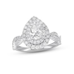 a white gold ring with an oval cut diamond surrounded by small round brilliant pave diamonds