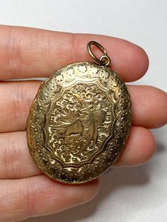 An amazing antique 9 karat gold locket. Featuring beautiful intricate floral scroll work on the front and back. You can put your desired photos inside the locket. The right side has a glass front inside. Not hallmarked but has been professionally tested for 9 karat gold at a jewellers. A beautiful locket pendant perfect to wear for any occasion Heavy weighing a total of 15.2 grams Measurements: The length is 4.2cm and the width is 3.2cm Condition: In really good antique condition. The fabric inside the locket on the left has been discoloured due to age. Please look at the photos as they are truly representative of the condition of this amazing locket All items are including postage tracked and signed for. Use the discount code MAGICJEWELS20 to receive €20 discount when purchasing two items Formal Yellow Gold Locket Necklace With Intricate Design, Ornate Yellow Gold Hallmarked Locket Necklace, Antique Gold Filigree Locket Necklace For Formal Occasions, Heirloom Filigree Locket Pendant Necklace, Oval Locket Necklace With Intricate Design For Anniversary, Victorian Filigree Locket Necklace In Yellow Gold, Victorian Yellow Gold Locket Necklace With Filigree, Victorian Oval Locket Necklace With Intricate Design, Victorian Filigree Yellow Gold Locket Necklace