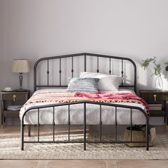 a bedroom with a metal bed frame and nightstands