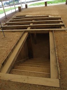 an open trench in the middle of a dirt field