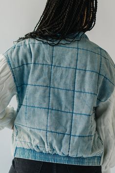 the back of a woman's jacket with braids