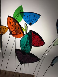 multicolored glass butterflies are hanging from the ceiling