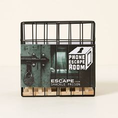 an escape from shackle prison sign is displayed on a white surface with wooden blocks