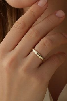 a close up of a person wearing a gold ring