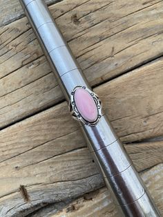 Pink conch ring... 1 1/16" tall by 5/8" wide at the widest spot handmade and signed in sterling silver with a beautiful ping conch shell cabochon with a high polish, which I cut.. the ring is a size 9 1/2 with a 6mm (1/4") wide shank in the back and can be sized some sizes sizes.. hard to take pictures, the stone is very shinny and reflects the light Pink Sterling Silver Vintage Jewelry, Vintage Pink Sterling Silver Jewelry, Pink Vintage Sterling Silver Jewelry, Pink Opal Sterling Silver Ring Gift, Pink Opal Ring In Sterling Silver For Gift, Vintage Pink Cabochon Ring, Handmade Vintage Pink Rings, Pink Oval Opal Ring In Sterling Silver, Handmade Sterling Silver Pink Rings