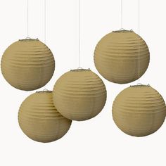 three round paper lanterns hanging from strings