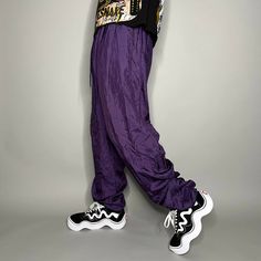 "Vintage Nylon Track Pants Grape Purple Joggers Baggy Fit Elastic Cuffs has Ankle Zippers Lined 90s Skate / Streetwear Great Condition: 9/10 Men's Size: X-Large My Hands in Pockets = It has Pockets No Hands in Pockets = Does Not Have Pockets Drawstring Will be Visible in Forward Pic, if not Visible it Does Not Have a Drawstring About me: I am 6' 0\" for reference I generally wear a Large (32\" inseam) I Model XS to 2XL sweatpants, I find that you can often size up or down with 95% of sweatpants and they fit the same" Trendy Nylon Parachute Pants For Streetwear, 90s Baggy Parachute Pants For Spring, Streetwear Nylon Bottoms With Elastic Cuffs, 90s Style Baggy Parachute Pants For Streetwear, Nylon Bottoms With Elastic Cuffs For Streetwear, 90s Baggy Parachute Pants, 90s Style Baggy Parachute Pants, 90s Style Parachute Pants For Spring, 90s Nylon Parachute Pants For Streetwear