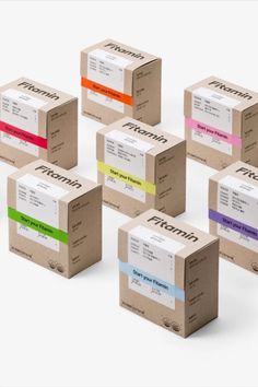 six boxes with different colored labels on each one and the same box as it appears