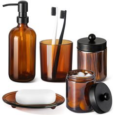 bathroom accessories including soap dispenser, toothbrush holder and glass container