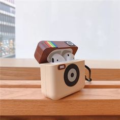 an apple airpods case sitting on top of a wooden table