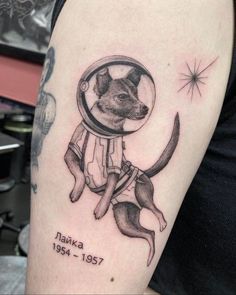 a dog in a space suit tattoo on the arm