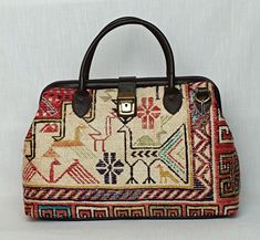 Welcome to AliDesignStore This Tote bag made of one of a kind Hand-sourced vintage Turkish Kilim Rug with supple cow leather. Suede-like interior. Measurements ; 40 cm x 29 cm x 14 cm  /   15,7''x11''x6'' İnch Handle drop height : 11cm  /  4.3'' inch (All mesurements are Approximate ) Adjustable Shoulder Strap - Handcrafted - Materials : Vintage Turkish Kilim Rug                        Supple Cow Leather                       Brass Accessories                       Suede-like interior - Ships from a small business in Turkey Luxury Traditional Tote Bag, Vintage Multicolor Satchel With Leather Handles, Traditional Satchel With Leather Handles For Everyday Use, Traditional Square Travel Bag, Traditional Rectangular Satchel For Travel, Traditional Beige Satchel Shoulder Bag, Traditional Tote Shoulder Bag With Detachable Handle, Traditional Travel Satchel With Handles, Traditional Shoulder Bag With Detachable Handle