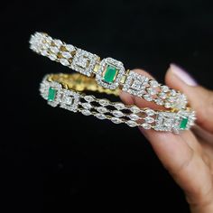 "* Handcrafted Gold Plated 4 Bangle Set. * Bangles with pretty Semi Precious Emerald ,CZ stones * High Quality 22 K Gold Plated- 2 Bangle set * Sizes : 2.2 has a 2.2\" inner circle diameter ; 2.4 ( 2.30\" diameter of the inner circle) ; 2.6 ( 2.46\" diameter of the inner circle); 2.8 (2.54\" diameter of the inner circle) 2.10 (2.60\"diameter of the inner circle) * Sold as a set of 2 Gorgeous gold-plated bangle/ bracelet best exemplifies the careful craftsmanship done on it -- a specialty at Nema Crystal Bangle Jewelry For Anniversary, Crystal Bangle For Anniversary, Stone Bangle Bracelets For Wedding, Wedding Diamond Bracelets With Jewels, Stone Bangle Jewelry For Parties, Party Bangle Jewelry With Stones, Cubic Zirconia Stones Bangle Jewelry, Wedding Jewelry Bangle With Jewels, Green Cubic Zirconia Bracelets For Wedding