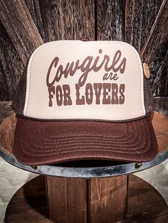 The Cowgirls are for Lovers Trucker Cap is a must-have for any cowgirl at heart. This tan and brown beauty features a mesh back for comfort, a snap back closure for convenience, and a whole lot of Western charm. Ride off into the sunset in style with this chic cap. OTTO Trucker Cap Foam Front OSFA Heat Pressed Design 100% Polyester Tshirt Prints, Aztec Hoodie, Hay Bag, Heat Press Designs, Spur Straps, Wrap Boots, Beauty Features, Silver Jewelry Box, Horse Accessories