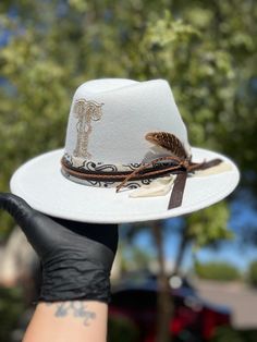 Please reach out to me  for a consultation on a custom, one of a kind hat that is the perfect accessory for any casual day, photo shoot or special occasion. Each hat is burned with any custom design and comes with a signature leather band. Send me a message today to bring your idea to life! Custom White Fedora For Country Events, Custom White Felt Hat With Short Brim, Custom White Hat Bands, Custom White Hat Bands One Size Fits Most, Custom White Wide Brim Hat, White Fedora With Short Brim For Festivals, White Adjustable Fedora With Flat Crown, Adjustable White Fedora With Flat Crown, White Short Brim Fedora For Festival