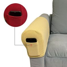 a grey couch with a red and yellow pillow next to it's back end