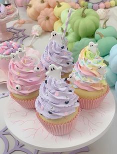 cupcakes decorated with pastel colors and sprinkles on a plate