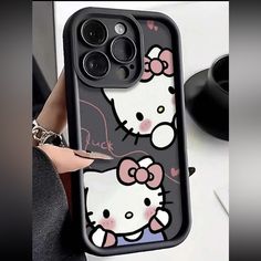 a woman holding up an iphone case with hello kitty on the front and back cover